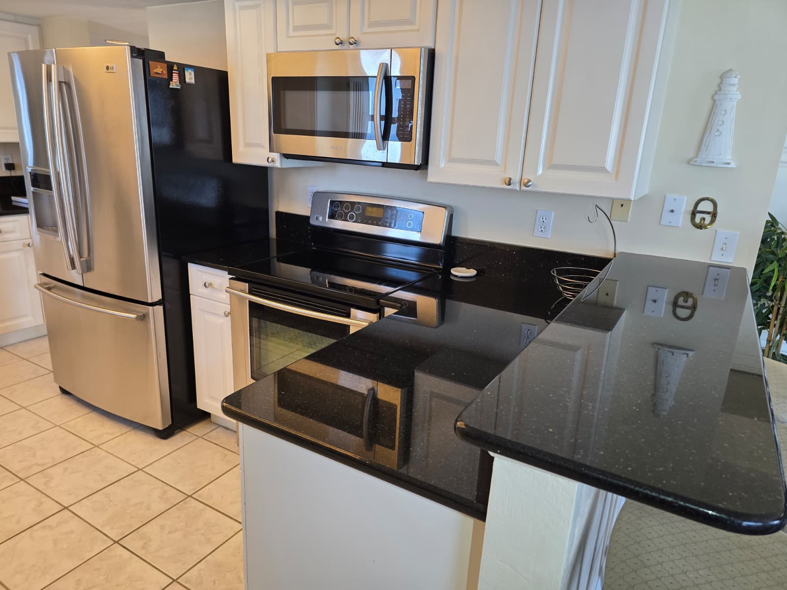 Full kitchen with plates and utensils. Breakfast bar with 3 seats.